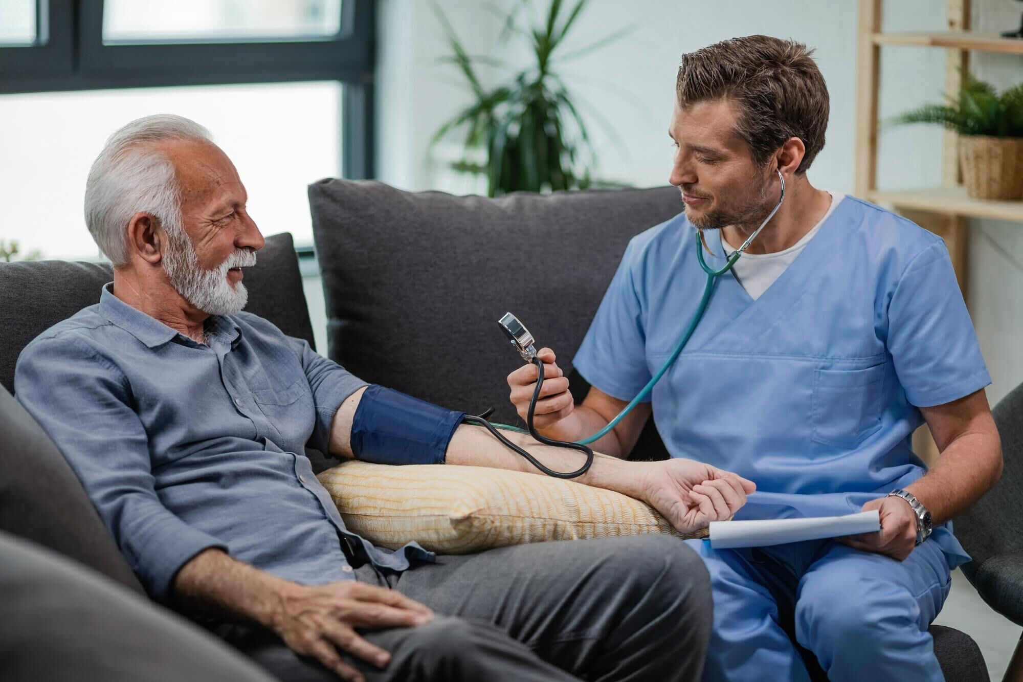 Home health care professional providing education and support during an in-home care visit.